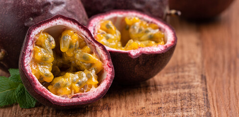 Delicious juicy passion fruit on wooden table background.