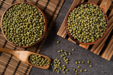 Raw mung bean on wooden table background.