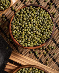 Raw mung bean on wooden table background.