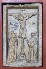 Stone bas-relief with a crucifix episode at the exhibition in the Castelvecchio Museum of the Castelvecchio Castello Scaligero fortress in Verona, Italy.