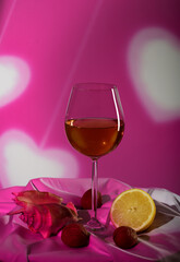 Still-life. Beautiful glass, lemon and clam shell on pink background with creative lighting