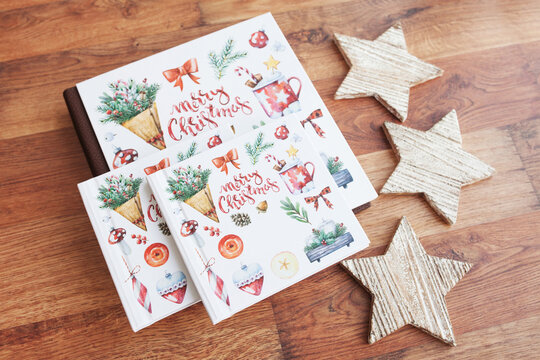 Family photo book with Christmas symbols. A wonderful gift for the holiday. Christmas, winter and new year holidays