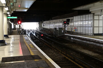 Looking out from the platform to the train exit of a London railway station.