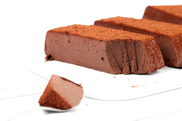 Chocolate mousse cake on a white plate. Soufflé made from cocoa liquor, coconut milk and agar-agar. Vegan desserts