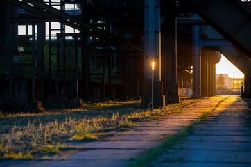Sunset at former blast furnace industrial site in Dortmund Ruhr Basin Germany. Warm beams of low...