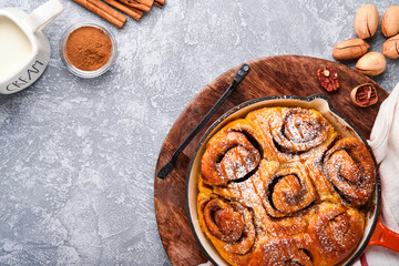 Cinnabon cinnamon rolls buns with pumpkin, nut, caramel and sugar cream iced. Top view. Sweet Homemade Pastry christmas baking. Close-up. Kanelbule - swedish dessert.
