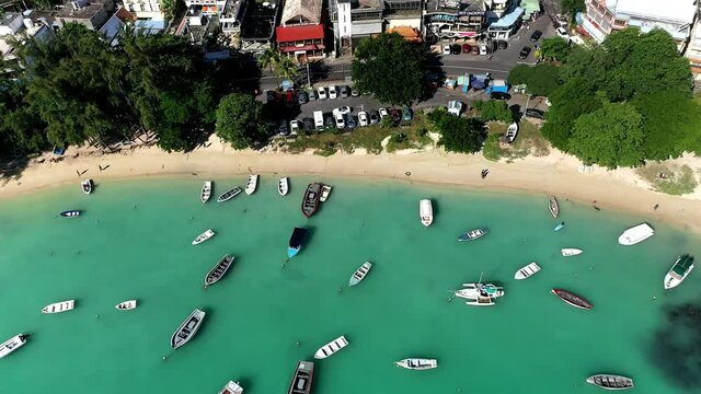 Aerial view, flight over beaches with luxury hotels with water sports and boats at Grand Baie Pamplemousses Region, Mauritius, Africa