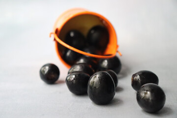 Sweet blue grapes scattered on white table
