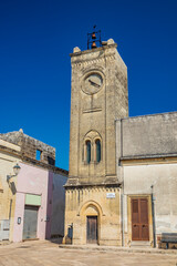 The small village of Acaya, Lecce, Salento, Puglia, Italy. The tower with the clock and the mullioned window. The small square paved in flat stone.