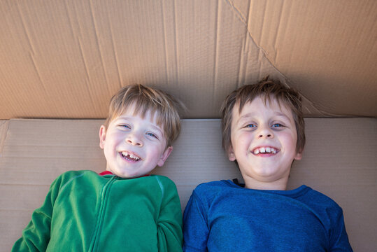 Cheerful boys having fun inside a large carton box