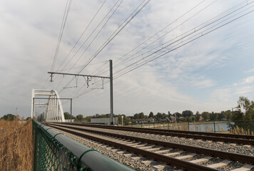 Fototapeta na wymiar Fencing of railway tracks and railway bridge in the countryside