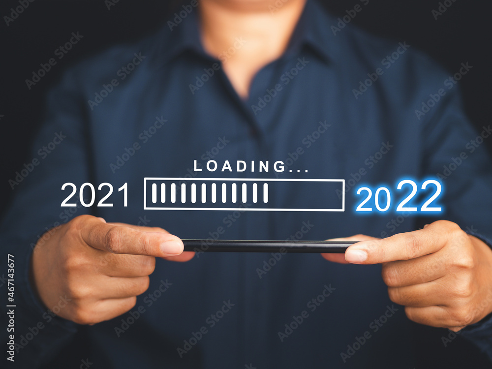 Poster countdown to 2022. display loading the year 2021 to 2022 on a virtual screen on top of a mobile phon