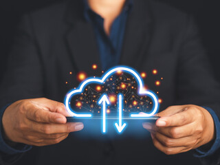 A smartphone connecting to a cloud computing system. Businessman in a suit holding a mobile phone login to the cloud system for transfer data on virtual screen. Network and technology concept