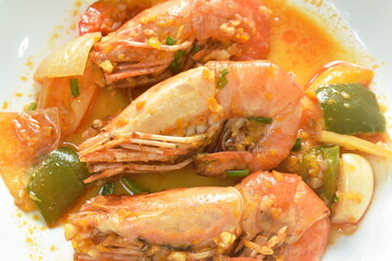 spicy stir fried river shrimp with chili and slice onion on plate