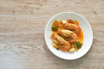 spicy stir fried river shrimp with chili and slice onion on plate