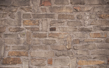 The texture of a stone wall with white patches