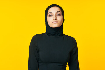 pretty woman muslim black hijab yellow background