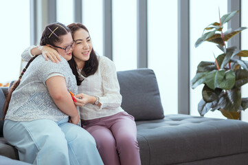 Obraz premium Girl with autism is practicing fun playing with toys at home with his mother.