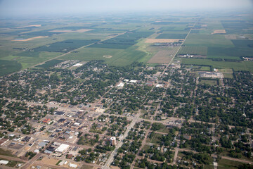 High aerial view of small farming town of Madison, South Dakota with farms in the background.