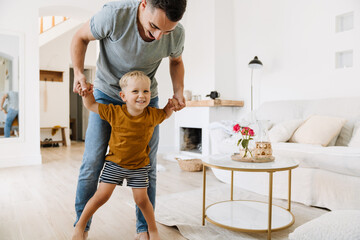 Young white father making fun and playing with his son