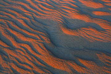 Wavy and narrow patterns in the sand before dawn