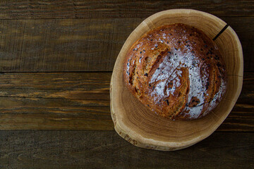 White bread on the board. On a wooden table. View from above