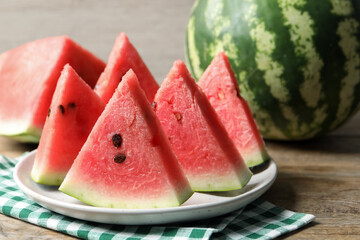 Delicious fresh watermelon slices on wooden table, closeup - obrazy, fototapety, plakaty