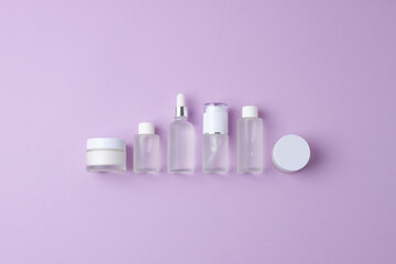 Cosmetic skin care products on rose background. Flat lay, copy space