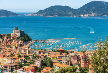 Naklejka premium Cityscape of Lerici and the Porto Venere or Portovenere, Tourist resorts on the coast of the Gulf of La Spezia, Mediterranean sea, Liguria, Italy, southern Europe. On horizon the Palmaria island.