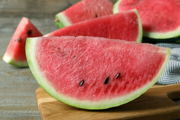 Delicious fresh watermelon slices on wooden table, closeup