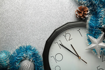 Christmas clock with christmas decoration on silver background. Happy new year concept.