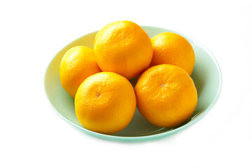 Fresh mandarin oranges fruit on mint bowl isolated on white background.