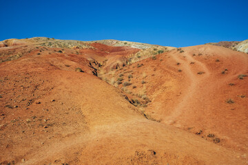  Altai Mars. Martian landscape. Orange clay, blue sky, desert in the mountains. Mountains and hills. Russia, Altai Republic.