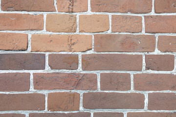 Brick wall. Red-brown brick with white grout.