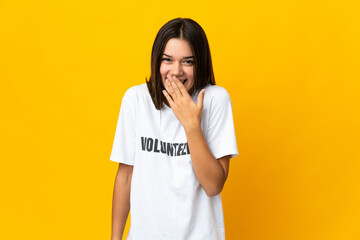Teenager volunteer girl happy and smiling covering mouth with hand