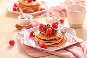 Sweet curd cheese pancakes with fresh raspberry, figs and maple sirup