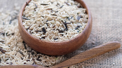 mixture of wild and white rice in a wooden bowl.