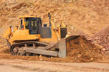 Bulldozer workflow for laying or leveling a technological road in a mining quarry