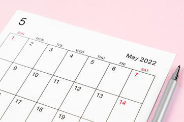 Fototapeta May 2022 calendar sheet with pen on pink background. obraz