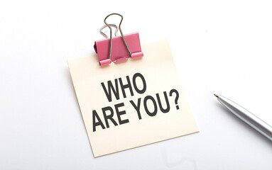 WHO ARE YOU text on sticker with pen on the white background