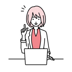 デスクで座ってPCを開いて何かひらめいたジャケットの女性