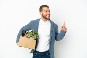 Young caucasian making a move while picking up a box full of things isolated on white background...