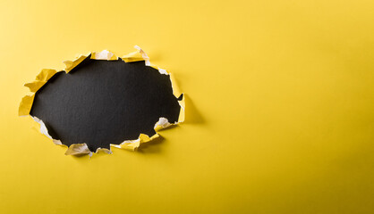 Top view of yellow torn paper on blackboard background. Black Friday composition.