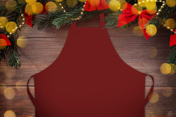 Christmas red apron mockup with Christmas decorations and bokeh on wooden background, mockup, flat lay, copy space