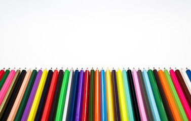 Creative back to school concept. Colored crayons against white background. Table top view, flat lay, copy space.