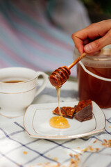 Tea Drinking with Honey and honey dripping off the spoon