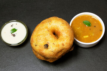 Image of an Indian Famous recipe called Vada a kind of deep fried snack made from lentils and spices.selected focus