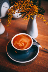 A cup of coffee with milk in a coffee shop