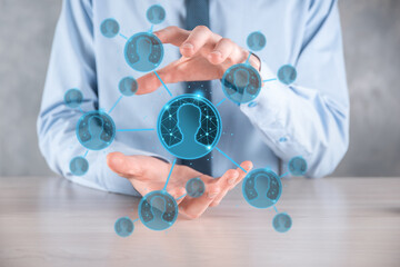 Fototapeta premium Businessman holding on hand icon of user man,woman low poly polygon style. Internet icons interface foreground. global network media concept.