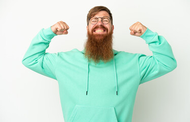 Young reddish caucasian man isolated on white background doing strong gesture